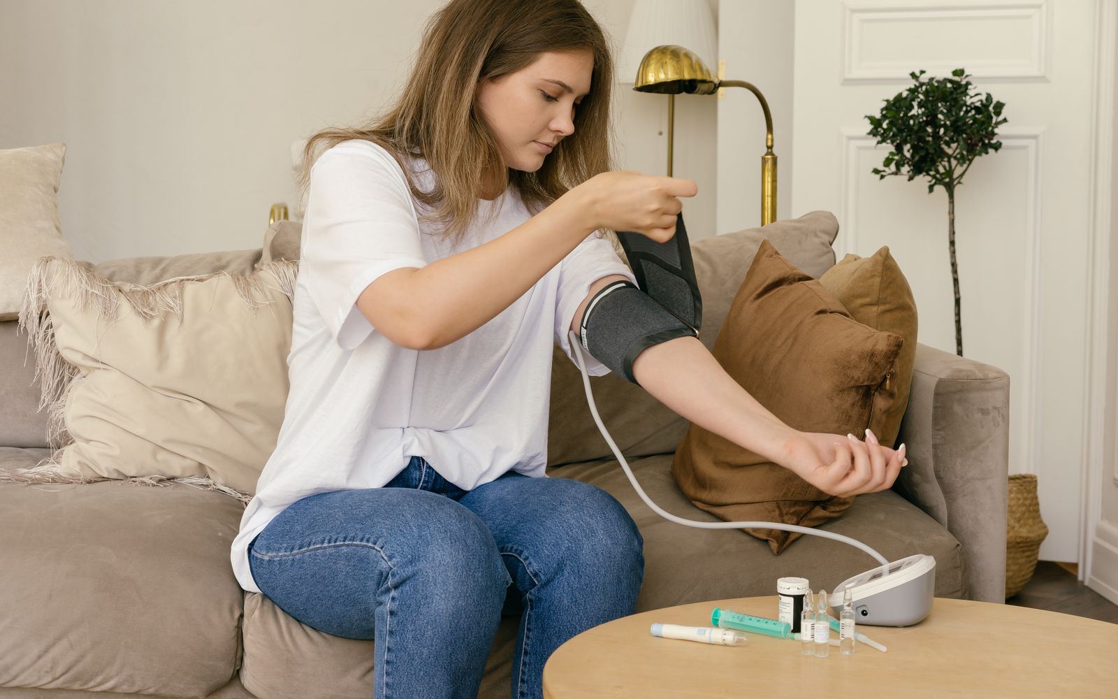 A woman checking her blood pressure at home